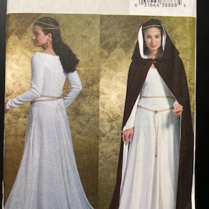 May include: Butterick sewing pattern B4377 for a long-sleeved white floor-length dress with a lace-up back and a dark brown hooded cloak. The package includes a barcode and size range EE 14-16-18-20 for creating these garments.