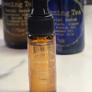 Puede incluir: Un peque&ntilde;o frasco de vidrio &aacute;mbar con un gotero negro. El frasco est&aacute; etiquetado como "Evening Tea" y contiene un suero facial. Los ingredientes incluyen almendras, aguacate y aceite de semilla de uva.