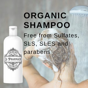 May include: White bottle of organic shampoo labeled "Skin and Body Sa Pharmacie Customized". The bottle is in front of a woman washing her hair in the shower. The text on the bottle reads "Organic Shampoo Free from Sulfates, SLS, SLES and parabens".