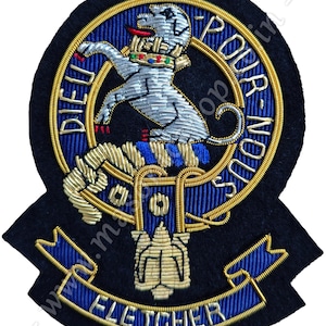 May include: Embroidered patch with a detailed design featuring a silver lion rampant, surrounded by gold and blue accents. The patch includes the text "DIEU POUR NOUS" and "FLETCHER" on a navy blue background.