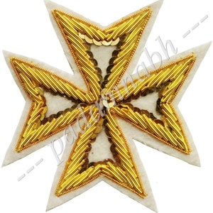 May include: A white felt patch with a gold embroidered Maltese cross. The cross is decorated with gold sequins.