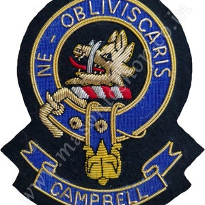 May include: A black and blue embroidered patch with a gold lion holding a sword, surrounded by a blue and gold rope border. The text "NE OBLIVISCARIS" is in gold lettering around the lion. The text "CAMPBELL" is in gold lettering on a blue ribbon at the bottom of the patch.