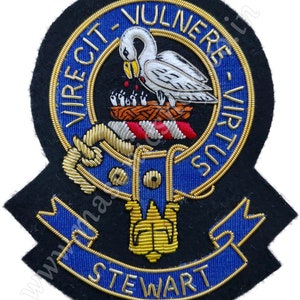 May include: A black and blue embroidered patch with gold trim. The patch features a white swan, a nest with chicks, and the word "STEWART". The patch has the words "VIRECIT-VULNERE-VIRTUS" in a circle.