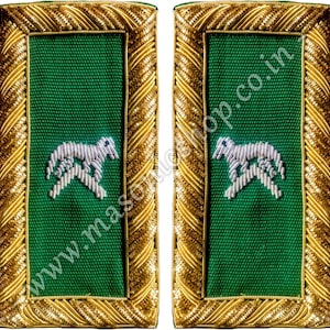 May include: Two green shoulder boards with a silver horse emblem. The boards are rectangular with a gold braided border. The text "www.masonics shop.co.in" is visible on the green fabric.