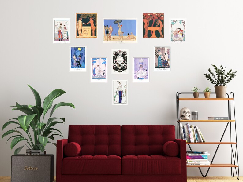 May include: A wall gallery featuring 12 framed art prints with various designs and colors. The prints are arranged in a symmetrical pattern on a white wall. The prints feature a variety of subjects, including people, animals, and abstract designs. The prints are all framed in simple, black frames.