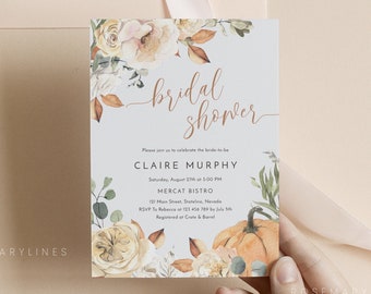 May include: A bridal shower invitation with a watercolor floral design featuring pumpkins, leaves, and flowers in shades of orange, yellow, and white. The text reads "bridal shower" in a copper-colored script font. The invitation includes the bride-to-be's name, the date, time, and location of the shower, and the RSVP information.