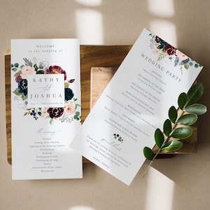 May include: Wedding ceremony program with floral design in shades of burgundy, pink, and blue. The program includes the wedding party, the ceremony order, and a special thanks message. The text reads "Welcome to the wedding of Kathy & Joshua".