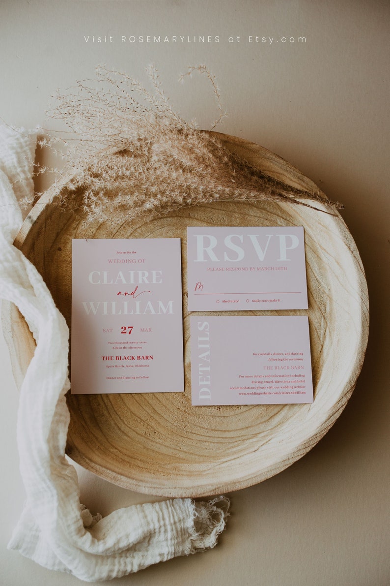 May include: A wedding invitation suite in pink, comprising an invitation, RSVP card, and details card. The invitation displays "Claire and William" and the date "27 MAR". The suite is presented in a wooden bowl, with the text "ROSEMARYLINES at Etsy.com".