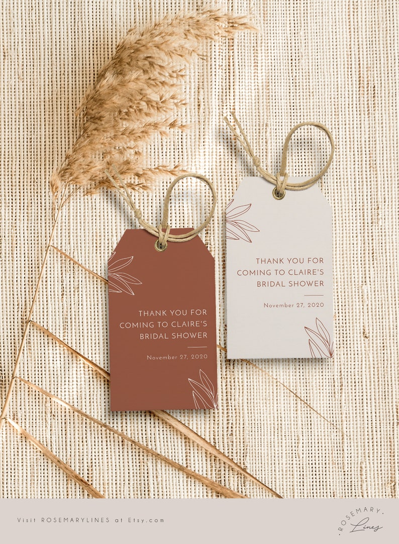 May include: Two gift tags with twine loops. One tag is terracotta, the other is light beige. Both tags have the text "THANK YOU FOR COMING TO CLAIRE'S BRIDAL SHOWER" and "November 27, 2020". Decorative leaf outlines are also present.