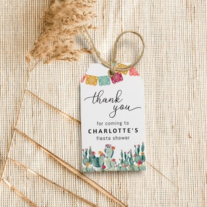 May include: A white thank you tag with a cactus and floral design. The tag says "thank you for coming to Charlotte's fiesta shower".