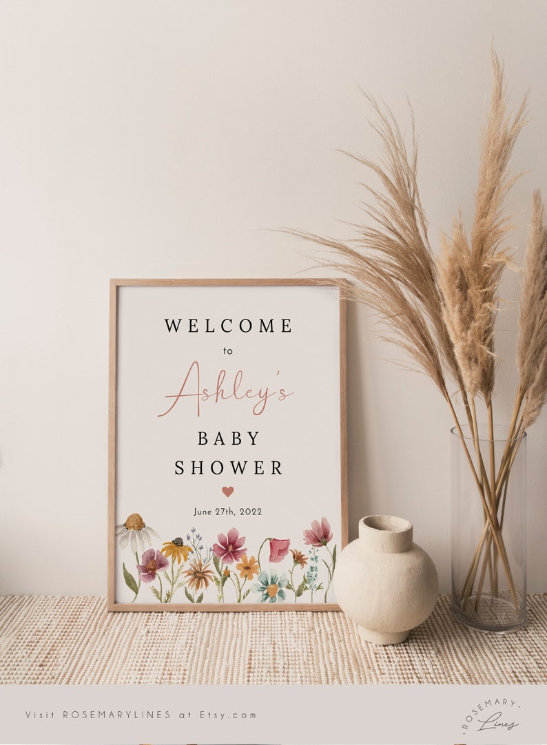 May include: A printable sign for a baby shower with a floral design and the text "Welcome to Ashley's Baby Shower June 27th, 2022".