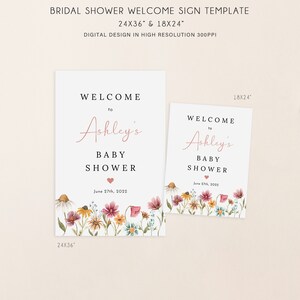 May include: Two printable welcome signs for a baby shower. The signs feature a floral design with a pink heart and the text "Welcome to Ashley's Baby Shower June 27th, 2022". The signs are available in two sizes: 24x36 inches and 18x24 inches.