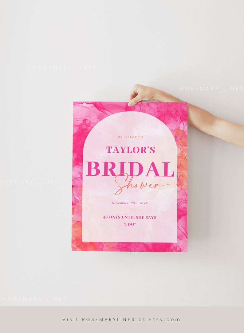 May include: A pink bridal shower sign with the text "Welcome to Taylor's Bridal Shower". The sign includes the date, and the phrase "48 days until she says I do". The background has a watercolor effect.