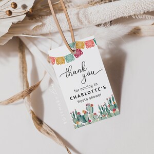 May include: Thank you for coming to Charlotte's fiesta shower. A white card with colorful paper banners and a cactus illustration.