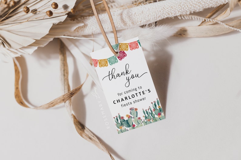 May include: Thank you for coming to Charlotte's fiesta shower. A white card with colorful paper banners and a cactus illustration.