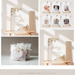 May include: Printable signs for a first birthday party with a fall theme. The signs feature a floral design with pumpkins and leaves in shades of orange, brown, and white. The text on the signs reads "cards and gifts", "thank you", "favors, please take one", and "one month", "two month", "three month", "four month", "five month", and "six month".
