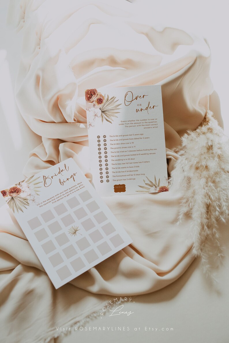 May include: Two wedding game cards with floral and botanical designs. One card is titled "Over or Under" with a list of questions. The other card is "Bridal Bingo". Both cards have a neutral color palette.
