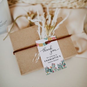 May include: A thank you tag with a cactus and floral design. The tag says "Thank you for coming to Charlotte's Fiesta Shower".