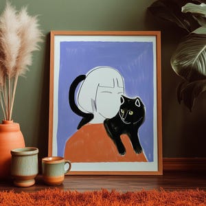 May include: A framed art print featuring a stylized illustration of a person with white hair and a black cat on their shoulder. The artwork has a blue background and is in a wooden frame. The room has a terracotta vase with pampas grass, two ceramic mugs, and an orange rug.