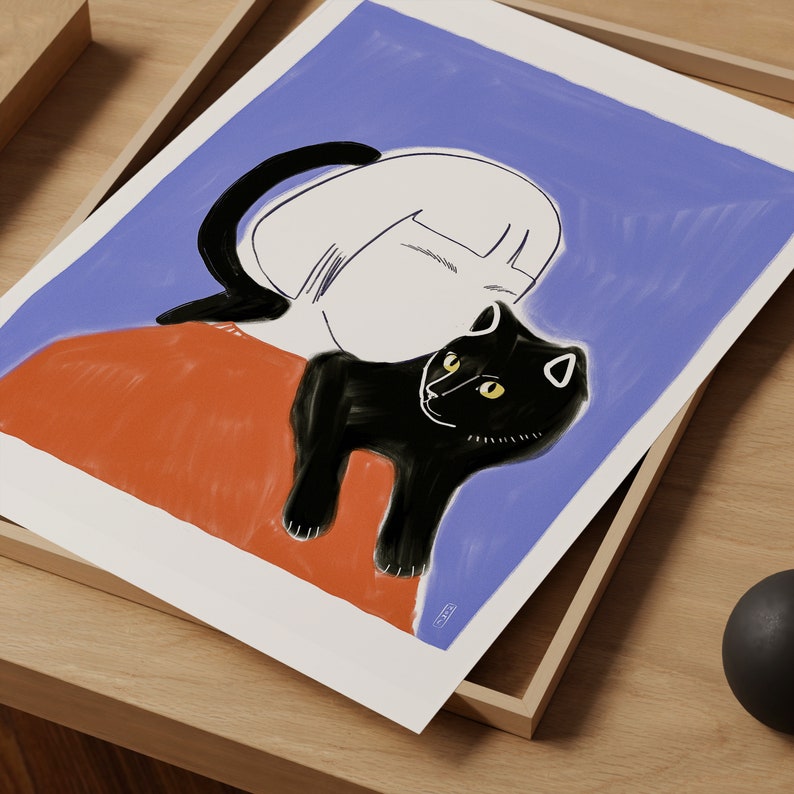 May include: Art print featuring a black cat with yellow eyes resting on a person's shoulder. The illustration has a minimalist style with a blue background and orange clothing. The artwork is displayed in a wooden frame.