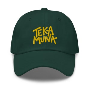 May include: A dark green baseball cap with a yellow embroidered logo that says "TEKA MUNA".