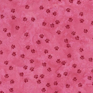 May include: Pink fabric with a repeating pattern of small red paw prints.