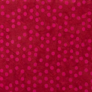 May include: Red fabric with a white polka dot pattern.