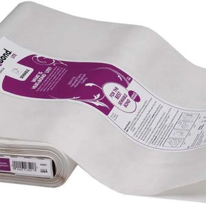 May include: A roll of HeatnBond Lite iron-on adhesive, with white fabric and a purple and white label. The label includes the text "WHAT IS HEATNBOND LITE?" and "FOR THE BEST SEWAGE BOND". The roll is made in the USA.