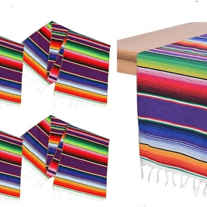 May include: Set of four colorful Mexican table runners with fringe. The runners feature a traditional serape pattern with stripes of red, orange, yellow, green, blue, purple, and white.