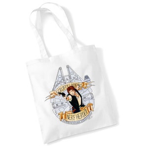 May include: White tote bag with a graphic of Han Solo from Star Wars. The graphic is a black and white illustration of Han Solo holding a blaster, with the Millennium Falcon in the background. The text "Scruffy Looking Nerf Herder" is written in a banner below the graphic.