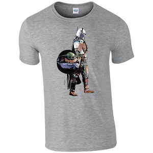 K&ouml;nnte beinhalten: Ein graues T-Shirt mit einem Grafikdruck eines Mandalorianer-Charakters aus Star Wars, der einen kleinen gr&uuml;nen Au&szlig;erirdischen, bekannt als Baby Yoda, in einer schwebenden Kapsel tr&auml;gt.