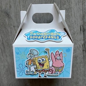 May include: A white gift box featuring the text "SpongeBob SquarePants" and cartoon characters SpongeBob, Patrick Star, and Squidward. The box has a handle and a light blue background with flower designs.