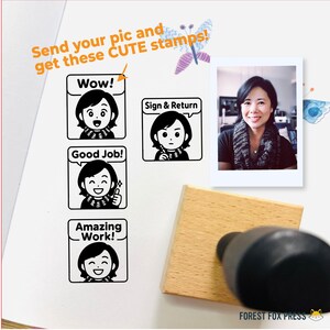 May include: Four black and white cartoon stamps with different messages: "Wow!" "Sign & Return" "Good Job!" and "Amazing Work!" Each stamp features a cartoon woman with a scarf. A wooden stamp is shown in the foreground with a black ink pad. The background is a white surface with a photo of a woman and some colorful drawings.