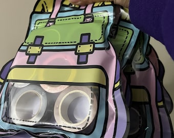 May include: Two clear plastic bags with a colorful cartoon backpack design. The bags are filled with rolls of colorful washi tape.