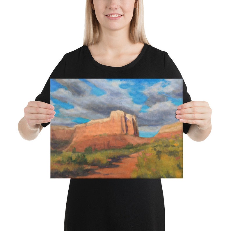 May include: A painting of a red rock formation in a desert landscape with a blue sky and white clouds. The rock formation is in the center of the image and is surrounded by green vegetation.