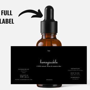 May include: A brown glass bottle with a black dropper and a black label. The label reads "honeysuckle" and "A 100% natural serum for sensitive skin." The bottle contains 60 ml / 2 oz of serum. The label also includes the website address and social media handles.