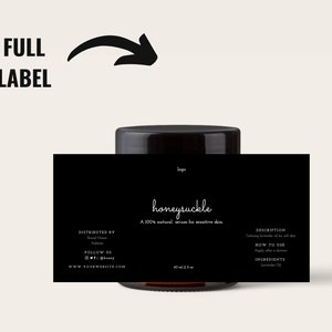 May include: A black label wraps around a brown glass jar, with the word "honeysuckle" in white script. The label states "A 100% natural serum for sensitive skin." The jar has a black lid and contains 60 ml / 2 fl oz of product.