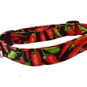 May include: A black dog collar with a red and green chili pepper print.