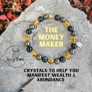 May include: A bracelet made of black, green, and gold beads with the text "The Money Maker" and "Crystals to help you manifest wealth & abundance".