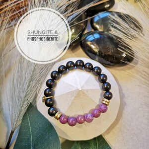 May include: A black Shungite and purple Phosphosederite beaded bracelet with gold accents.