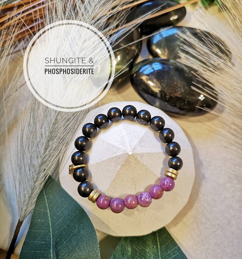 May include: A black Shungite and purple Phosphosederite beaded bracelet with gold accents.