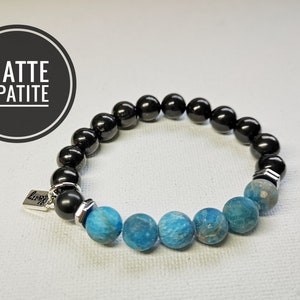 May include: A black and blue beaded bracelet with a silver charm that says "love". The bracelet is made with matte apatite and black onyx beads.