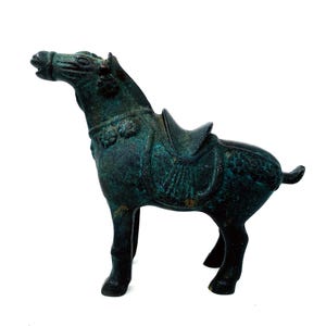 Vintage Decorative Chinese sculpture of a horse with saddle, heavy magnetic metal sculpture with a green patina or oxidation,