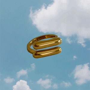 May include: Gold ring with two rectangular bars, one on top of the other. The ring is engraved with the words "YOU AND I".