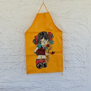 Vintage Minky England Child's Apron, Outer Plastic,  Yellow with Little Girl and Flowers, Made in England, 1970s