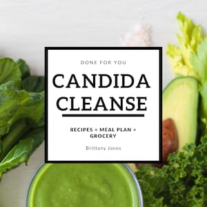 May include: Image featuring a green smoothie in a glass, surrounded by fresh produce like kale, avocado, and celery. The text "CANDIDA CLEANSE" is displayed in a black square, with additional text indicating recipes, meal plans, and grocery lists.