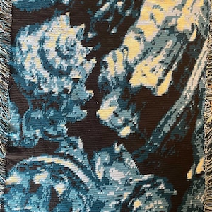 May include: A woven tapestry featuring an abstract design in shades of blue and black. The design incorporates swirling patterns and shapes in shades of blue, white, and yellow.