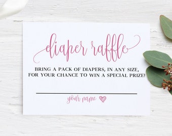May include: A white card with the words "diaper raffle" in pink script. The text below reads "BRING A PACK OF DIAPERS, IN ANY SIZE, FOR YOUR CHANCE TO WIN A SPECIAL PRIZE!" with a line for a name and a heart.