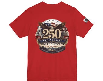May include: A red t-shirt with a commemorative graphic for the 250th anniversary of the United States of America. The design includes an eagle, the American flag, the Statue of Liberty, and the Capitol building, with the years 1776 and 2026.