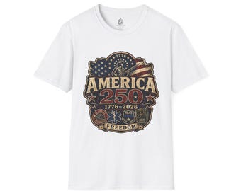 May include: A white short-sleeved t-shirt featuring a graphic print with an American flag, a soldier, and the text America 250, 1776-2026, and Freedom. The design includes icons for fire rescue, medical services, and police, with a distressed aesthetic.